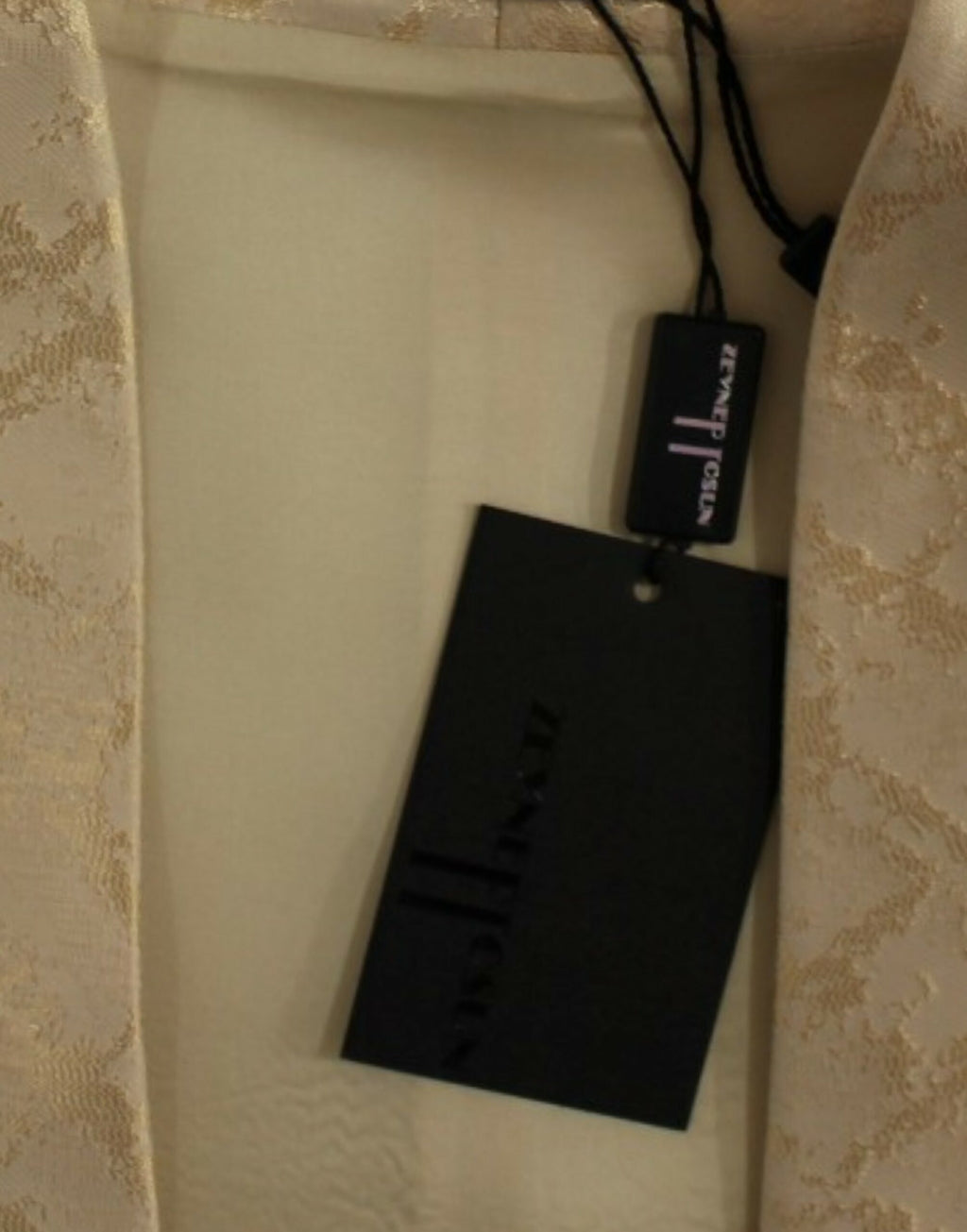 Beige ärmellose Jacke aus Brokat