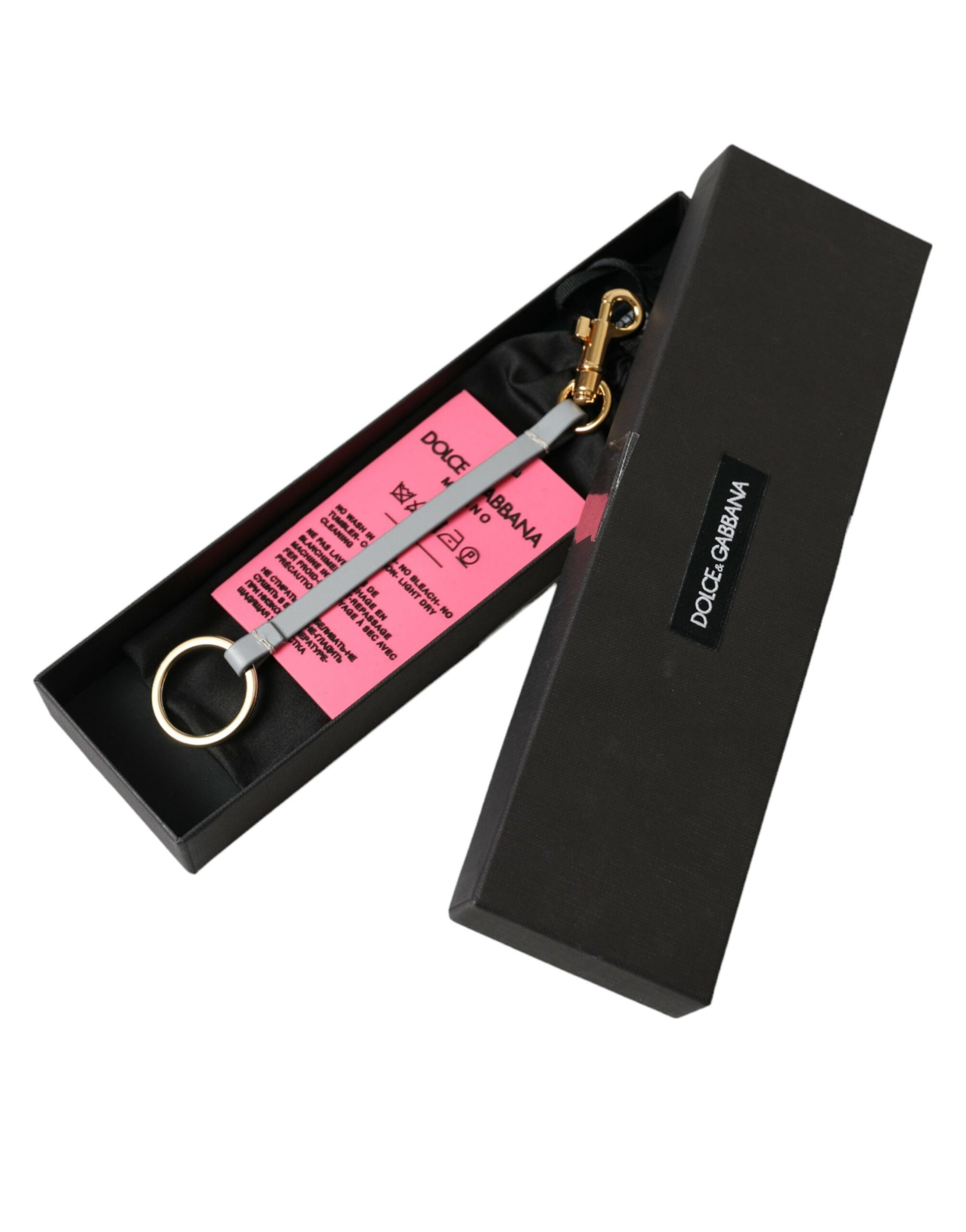 Schlüsselanhänger aus rosa Silikon mit DG-Logo und goldenem Messing